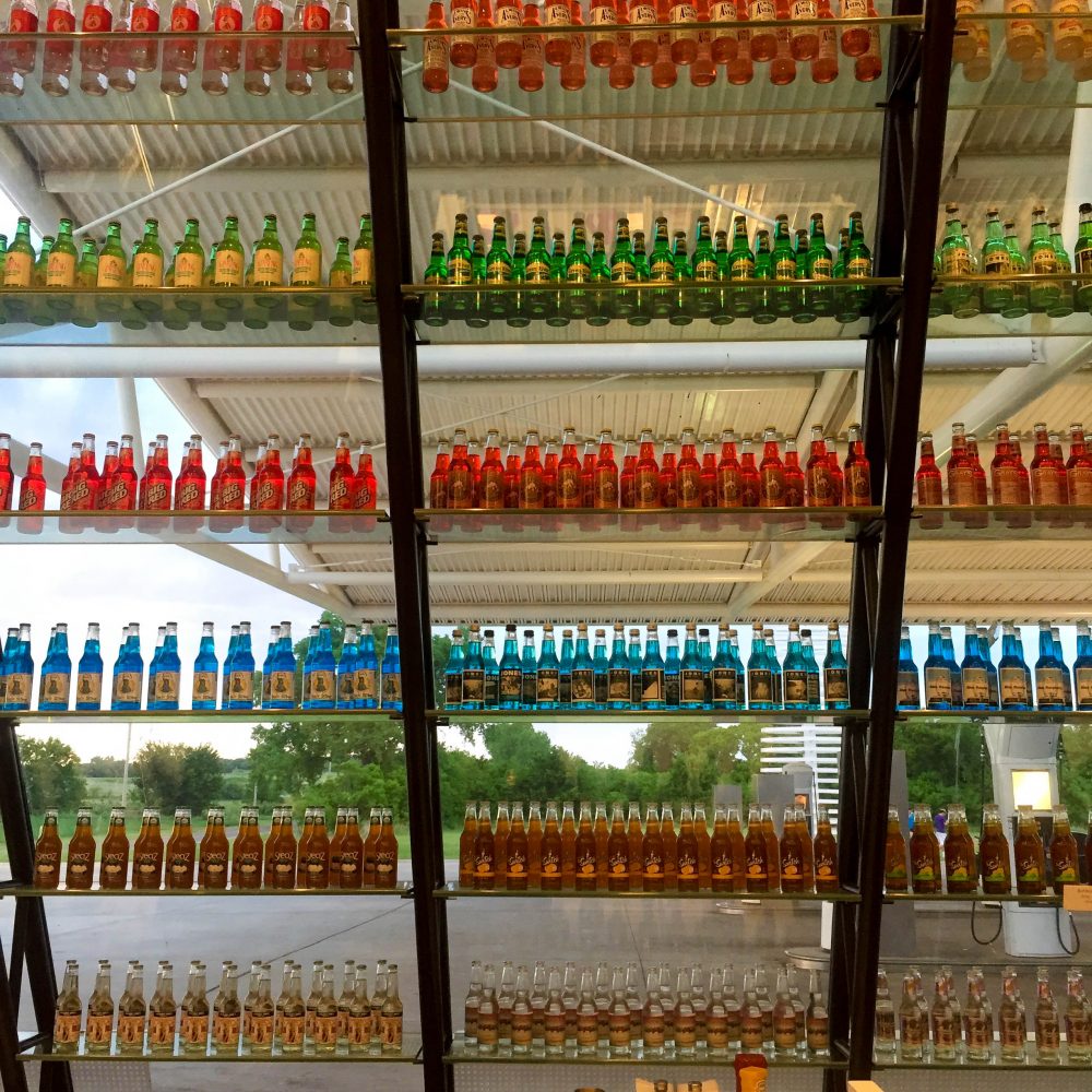 old fashioned sode bottles lined up on glass shelves