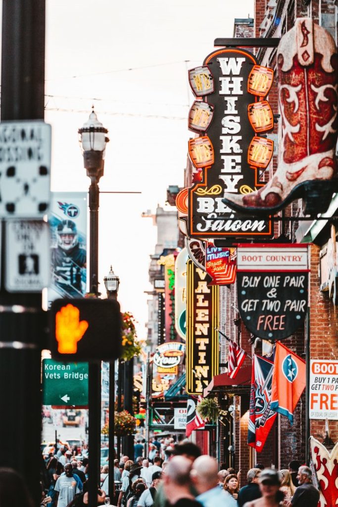 a busy street with neon signs in Nashville