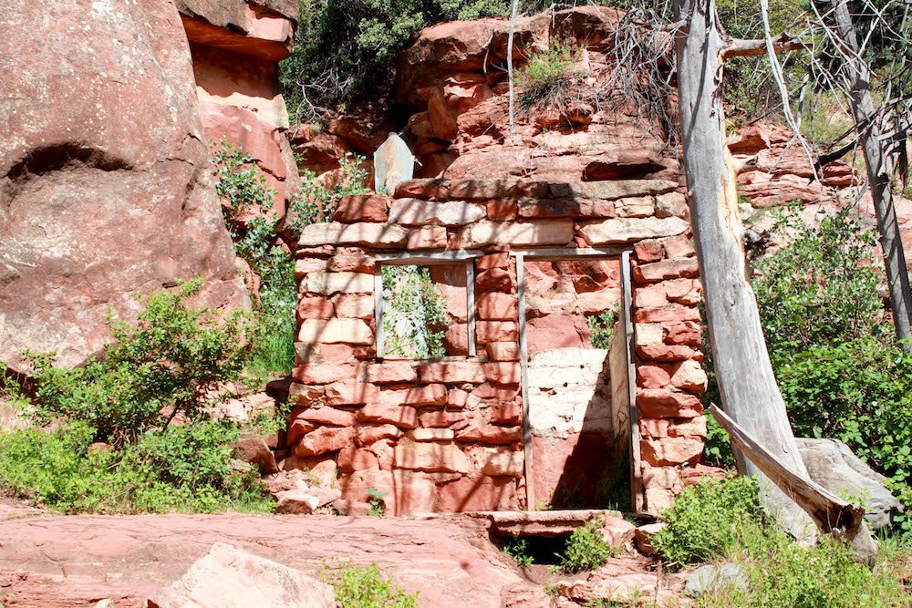 a small brick building in slide rock state park
