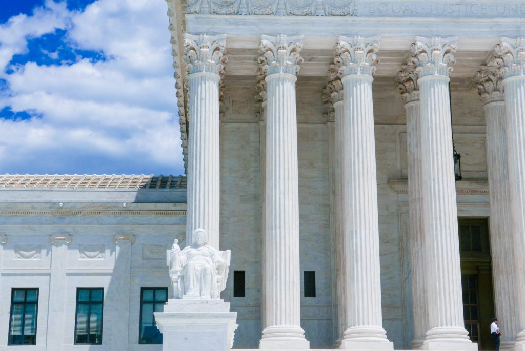 A close-up of the outside of the Supreme Court Building, with many columns