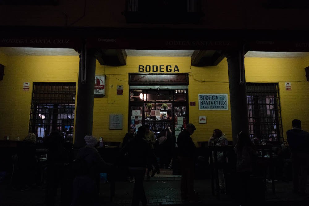 Yellow Storefront of Bodega Santa Cruz Las Columnas Tapas Bar in Seville, Spain