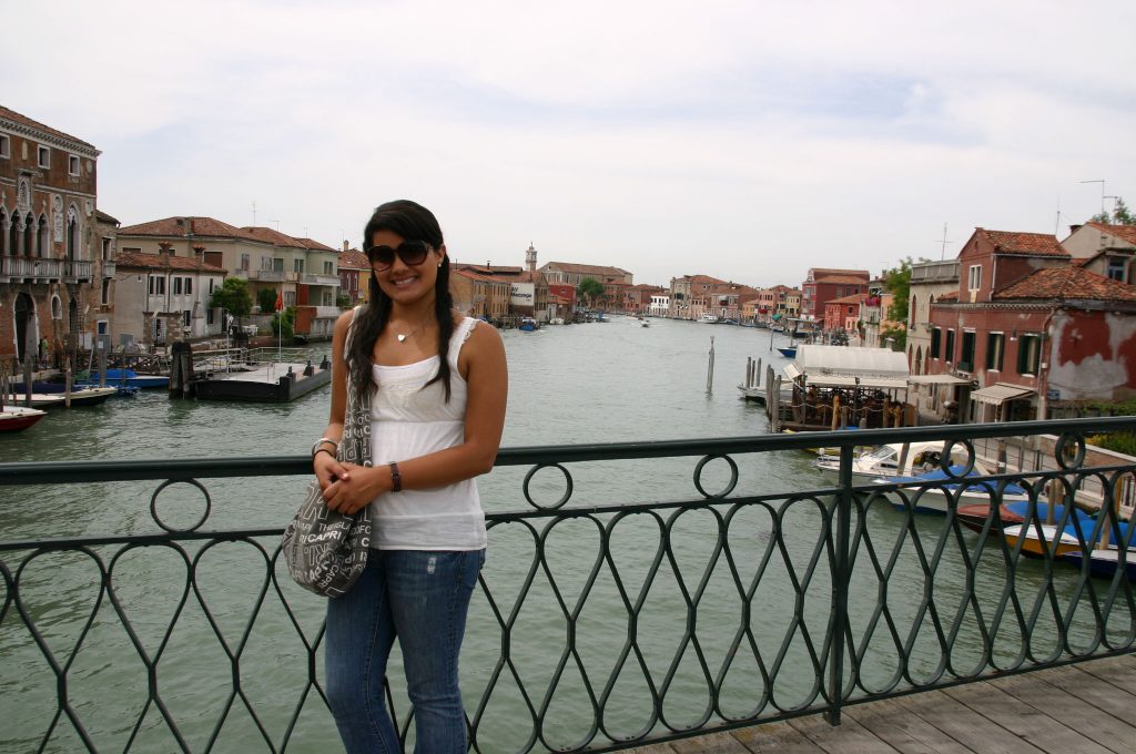 Girl smiling on a bridge while studying abroad in Italy