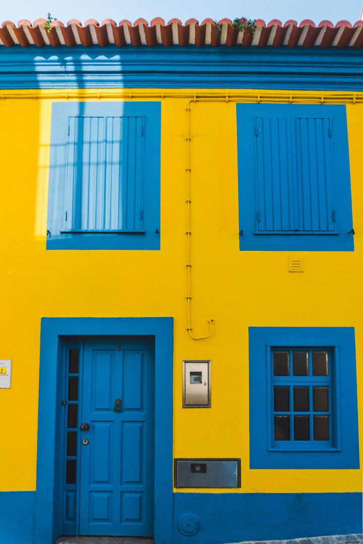 A tellow house with blue door and windows in Aveiro, Portugal airbnb