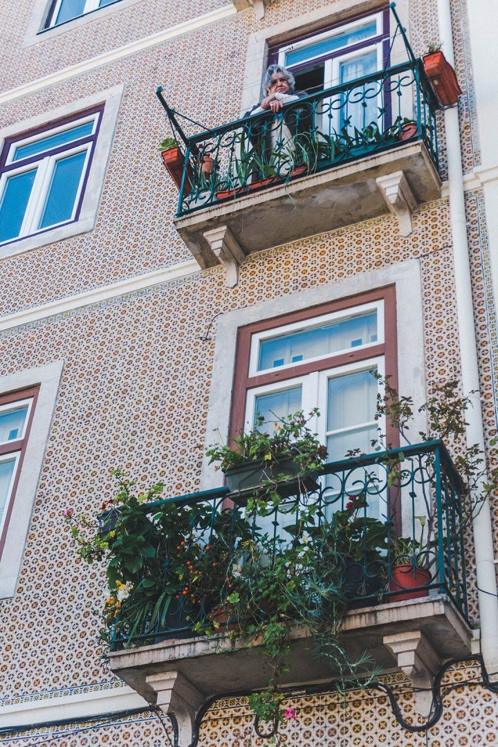 A grandma on a balcony in Lisbon, Portugal