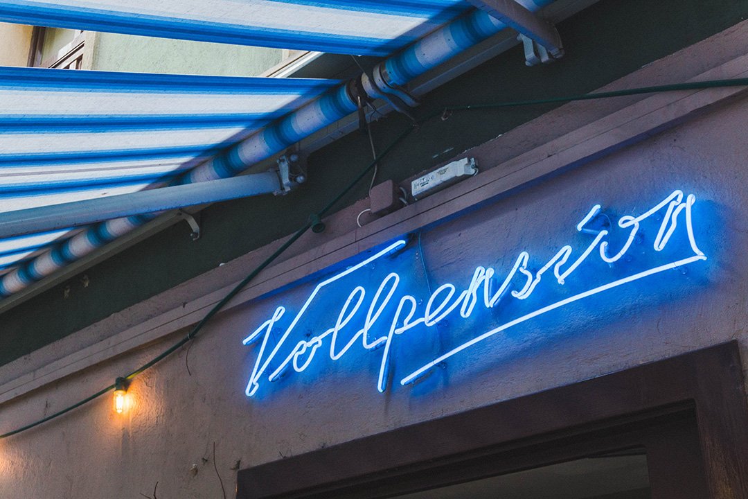 Blue neon Cafe Vollpension sign in Vienna, Austria