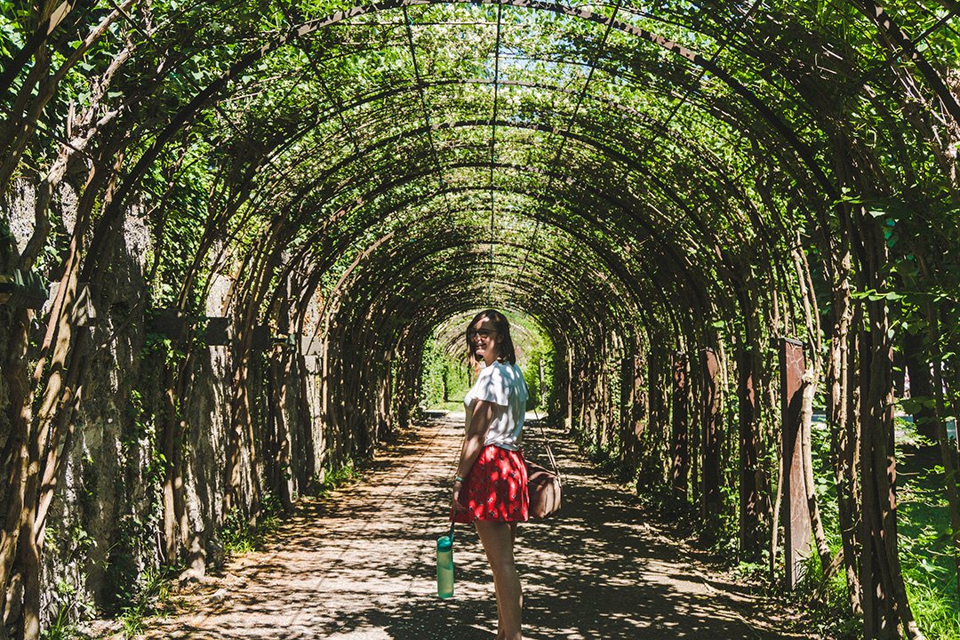 Addie wandering through an ivy tunnel in the Mirabell Gardens Salzburg, Austria