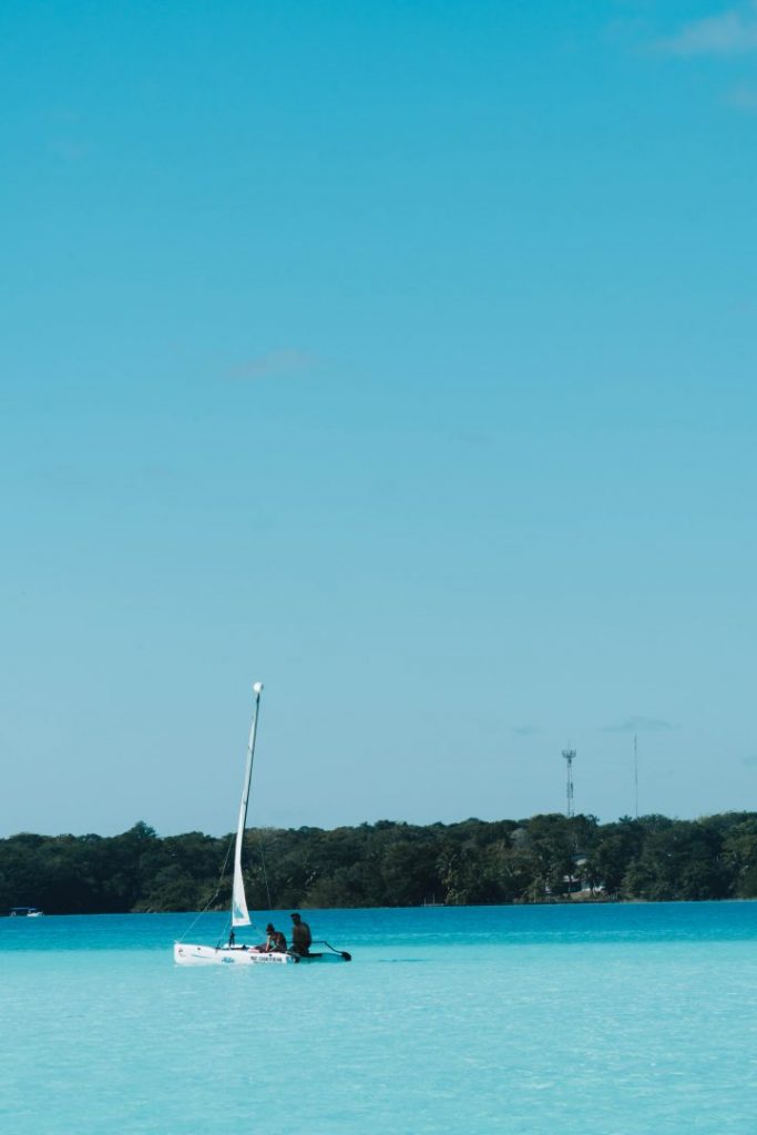 A boat on the bright blue Bacalar Lagoon