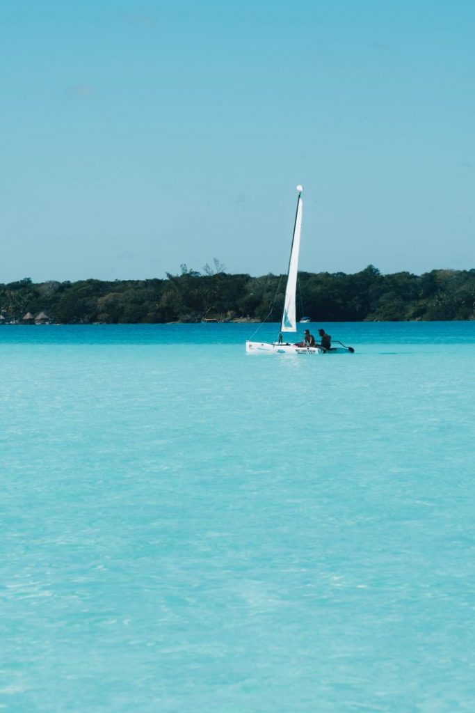 A catamaran on the bright blue Bacalar lagoon