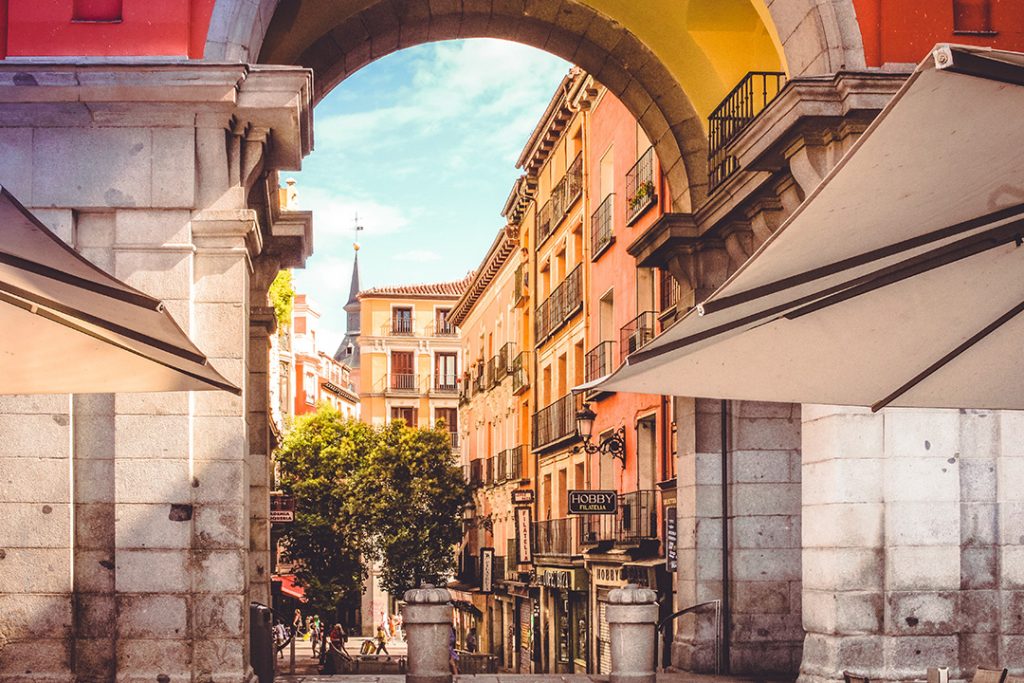 A square peaking through an archway in Madrid, Spain
