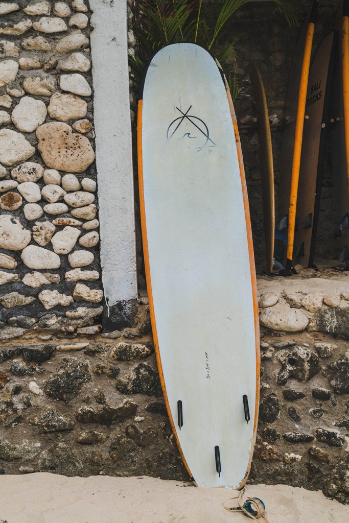 A surfboard leaning against a wall at Dreamsea Uluwatu