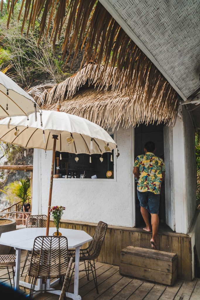A waiter walking into the kitchen at this bali surf camp cafe