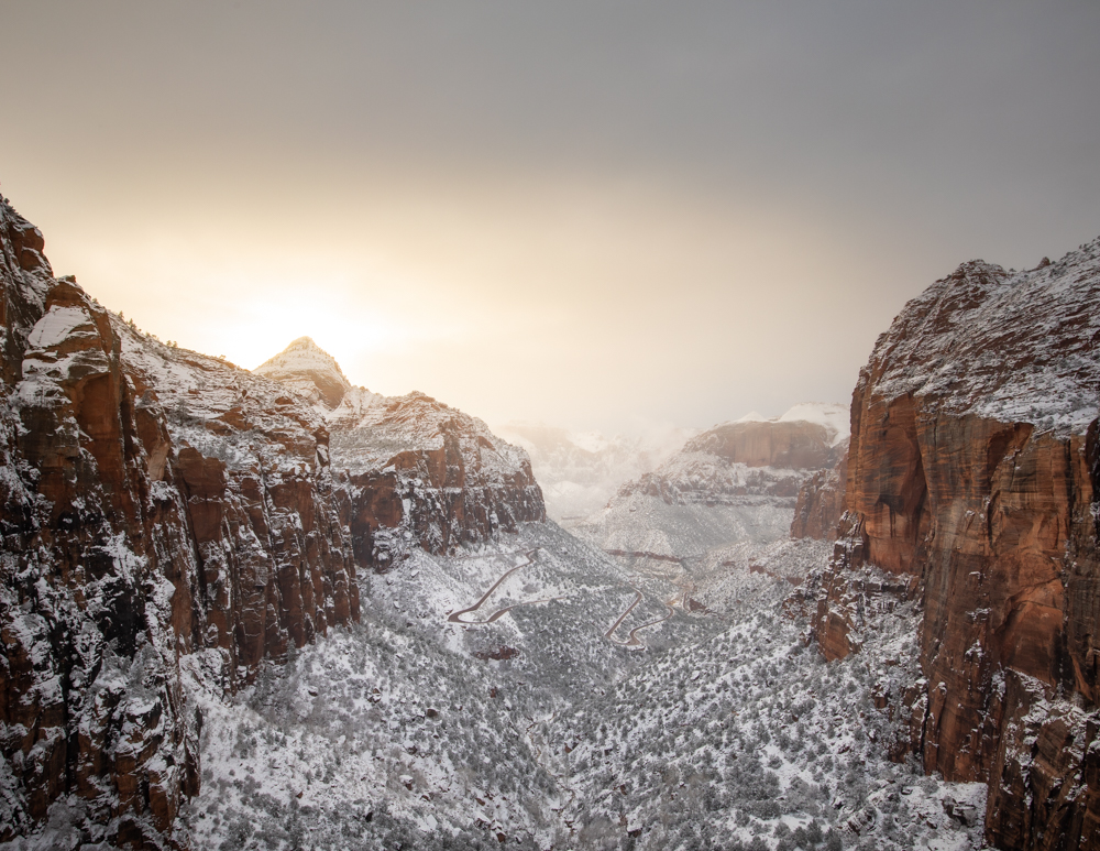 red mountains covered in snow in zion national park in winter - one of the most beautiful places to visit in winter in USA