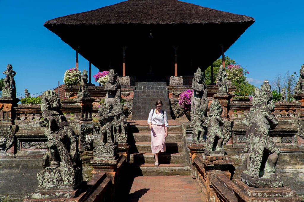 Addie walking down the steps of a temple near Ubud