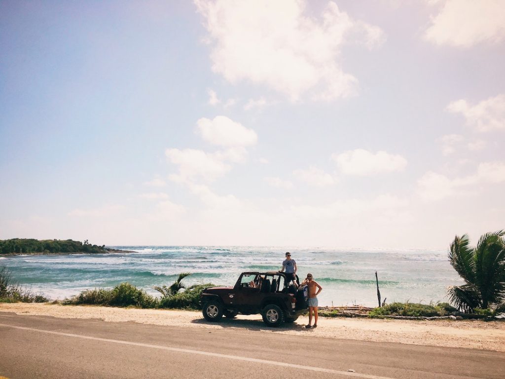 two guys and a jeep by the ocean in Cozumel, Mexico