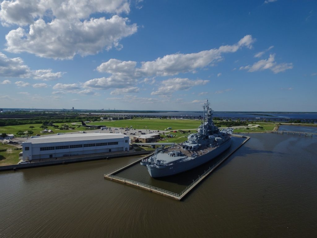 a grey ship, the USS Alabama at deck in Mobile, AL