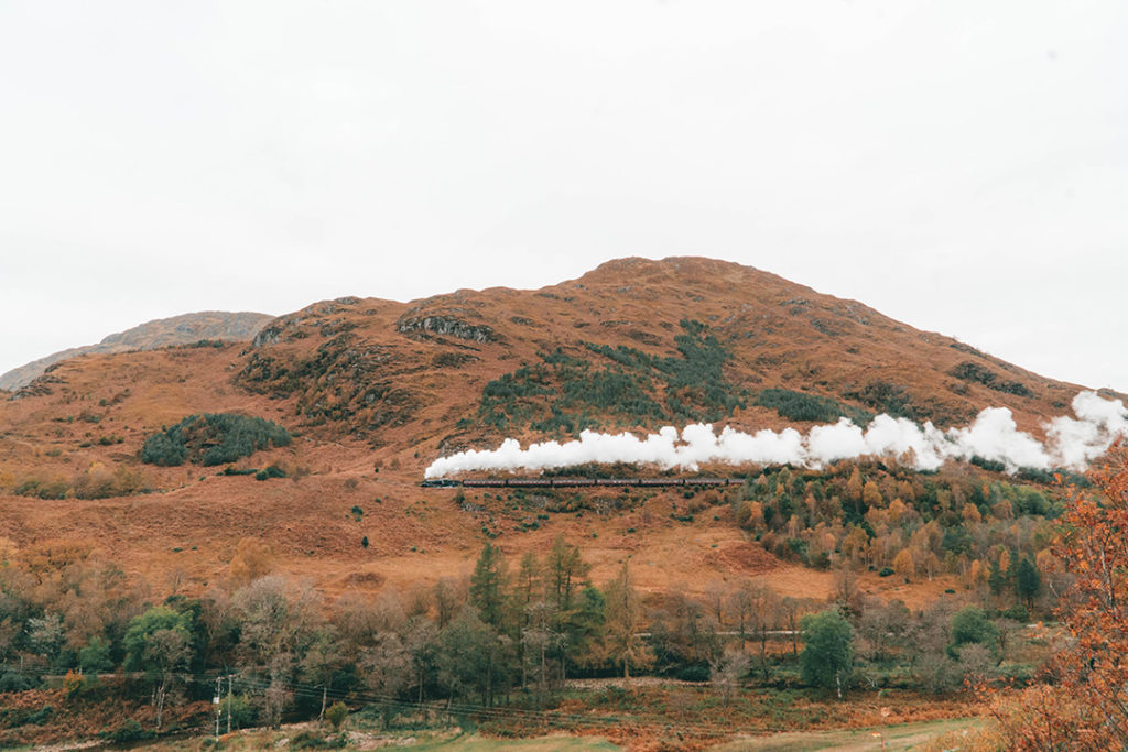 the jacobite steam train on a hill during an isle of skye tour from edinburgh