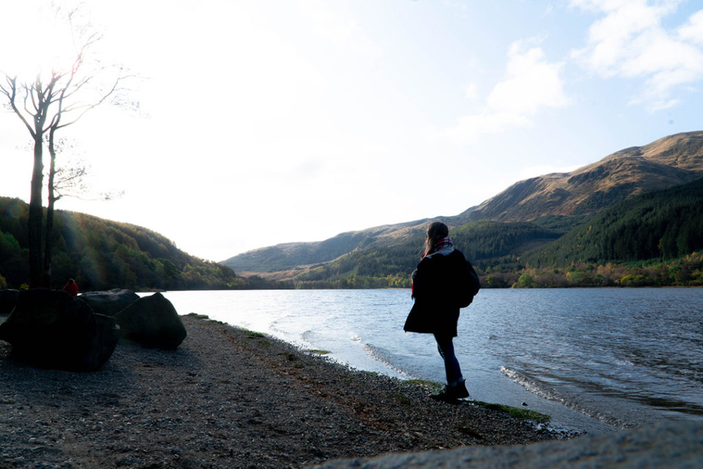 Addie standing on the rocky shores of Loch Lubnaig