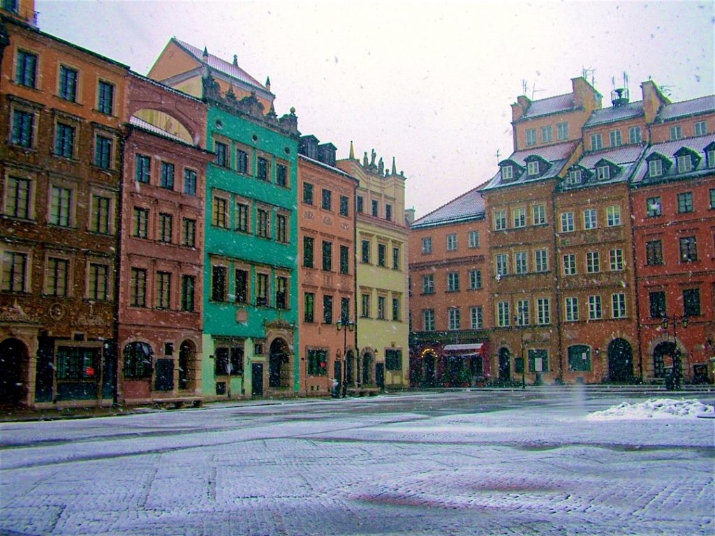 colorful houses in the snow in a square in Warsaw, Poland