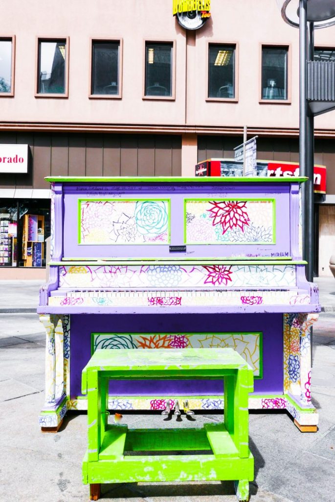 a colorful painted piano on Denver's 16th Street Mall