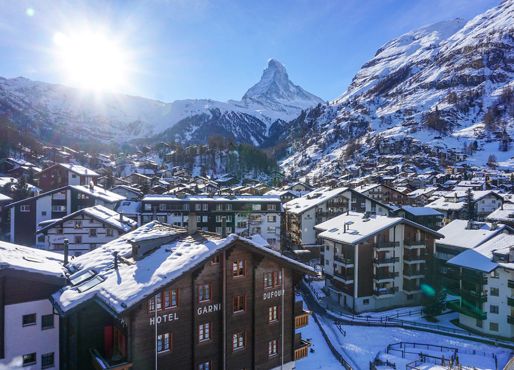 The sun over the town of Zermatt and the Matterhorn