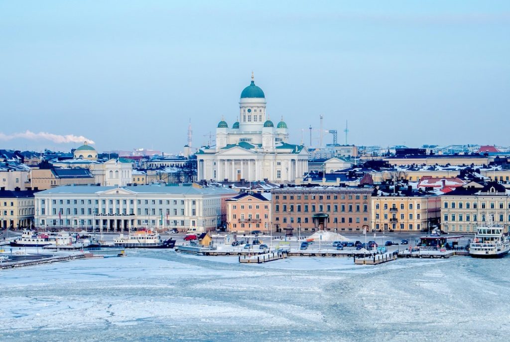 They skyline of Helsinki by a frozen lake
