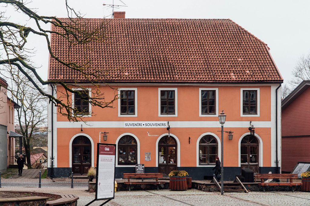 an orange building in old town cesis, latvia