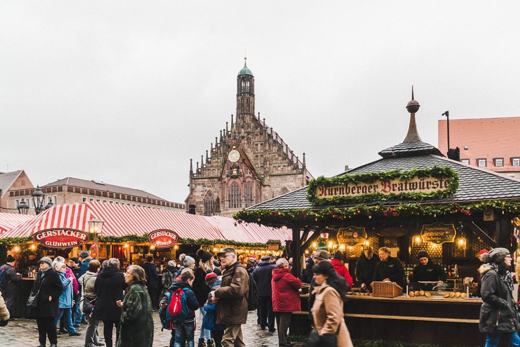 Nuremberg Christmas Market with a church in the background in daytime