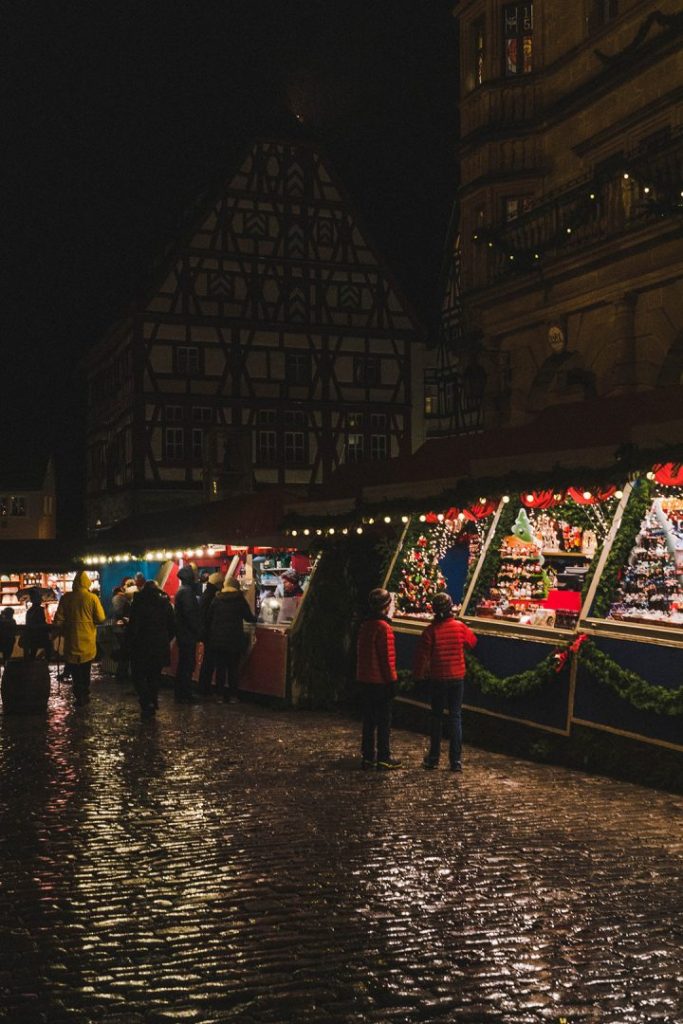 A row of lit up christmas market stalls