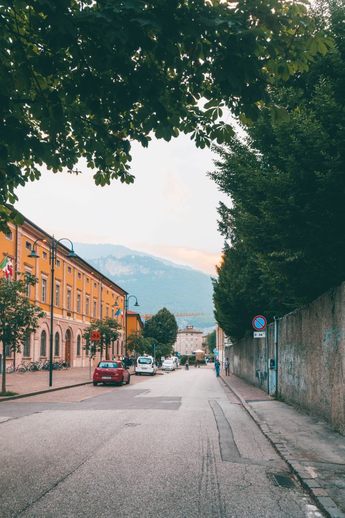 a road in Trento, Italy with mountains in the background
