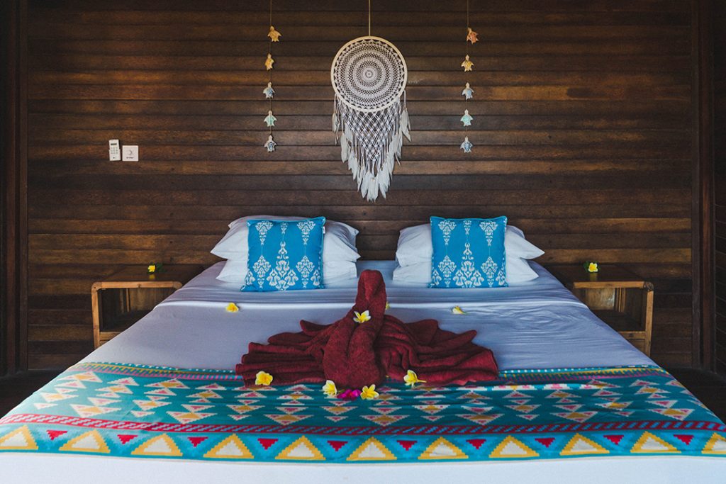 a bed with a towel swan on it at the Twin Island Villas on Nusa Lembongan - nusa islands guide