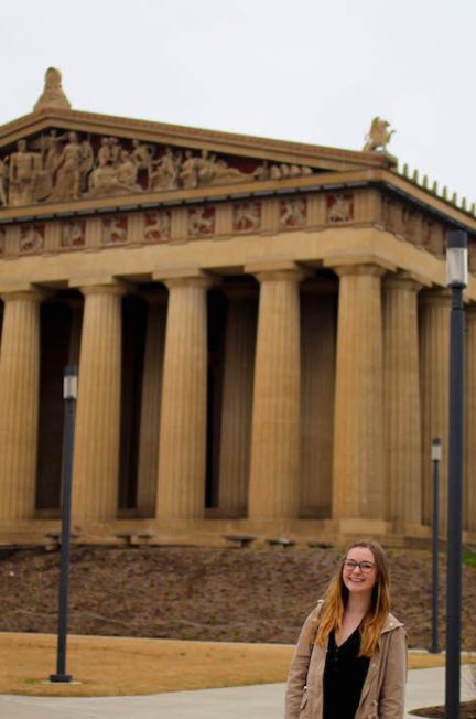 Addie smiling in front of the Nashville Parthenon