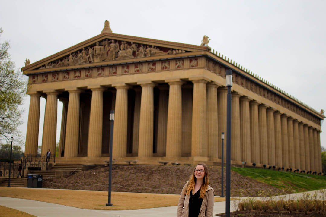Addie smiling in front of the Nashville Parthenon
