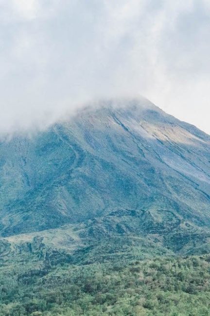 Arenal Volcano peeking through the clouds in La Fortuna, Costa Rica