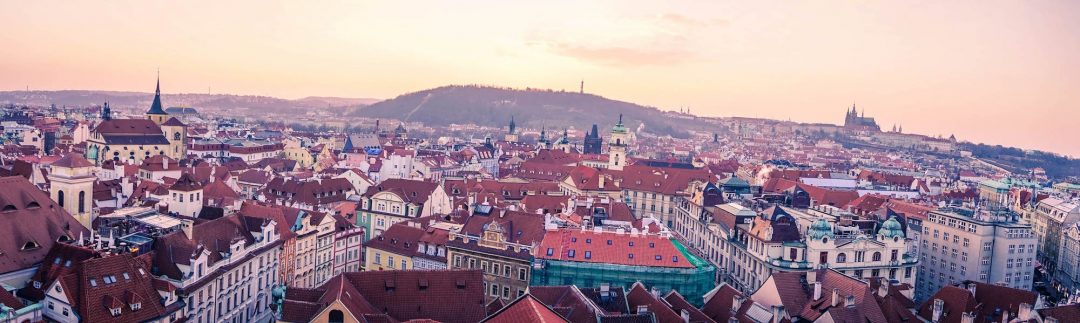Panorama looking towards Petrin Hill over the roofs of Prague at Sunset