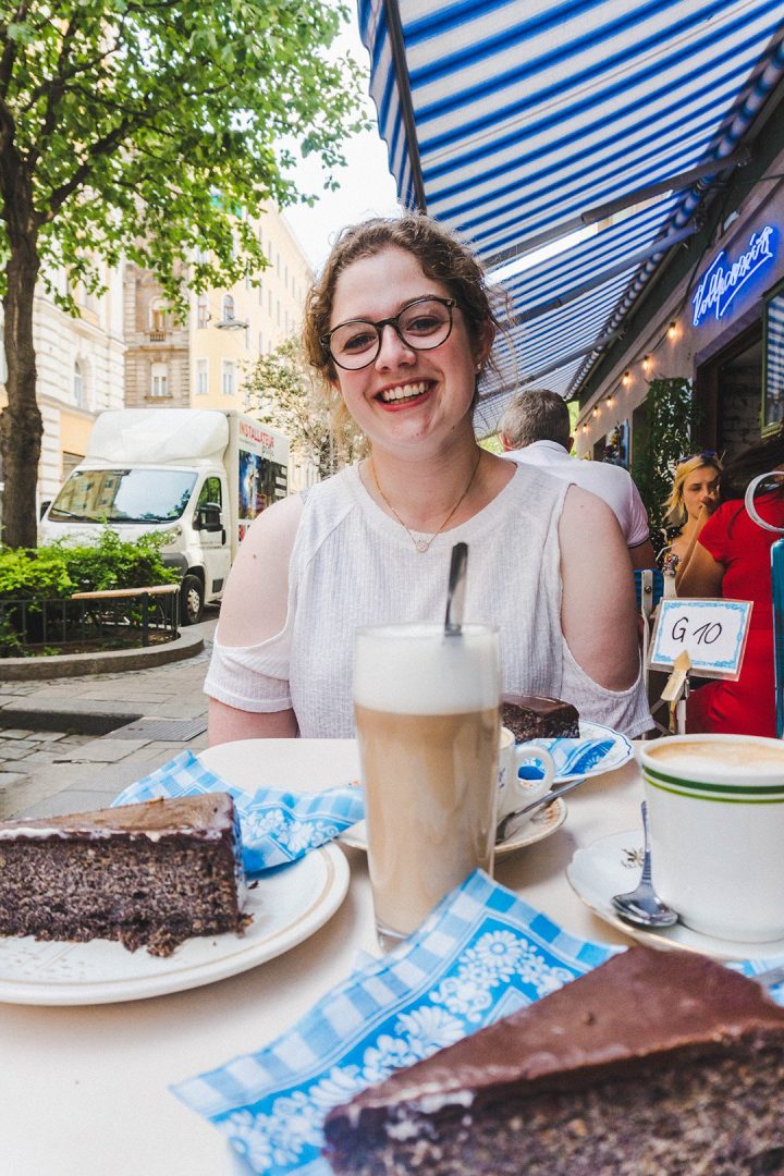 Astrid with cake and coffee at Cafe Vollpension in Vienna, Austria