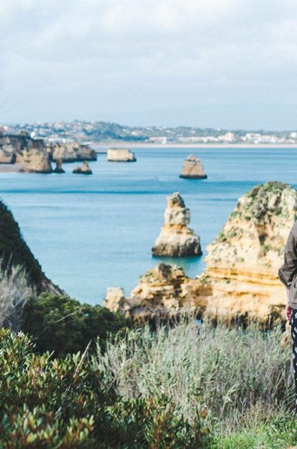 Madison staring out at the cliffs of Lagos, Portugal