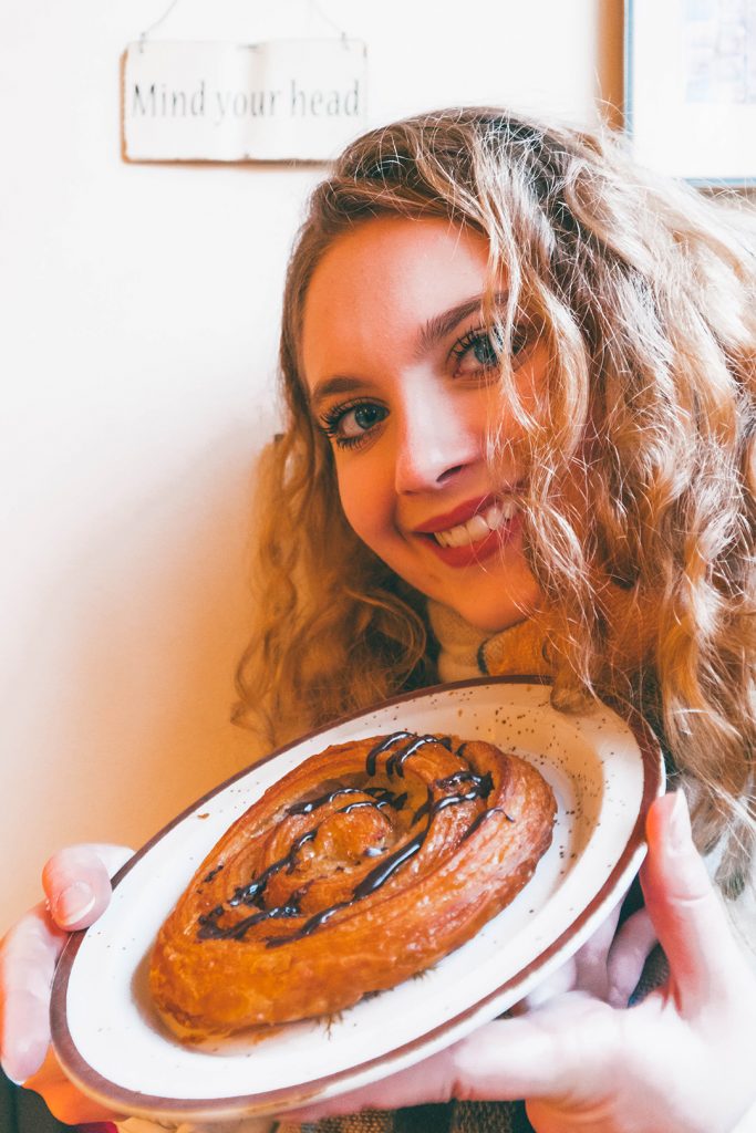 Megan with a chocolate snail pastry at a bakery on our hygge tour Copenhagen