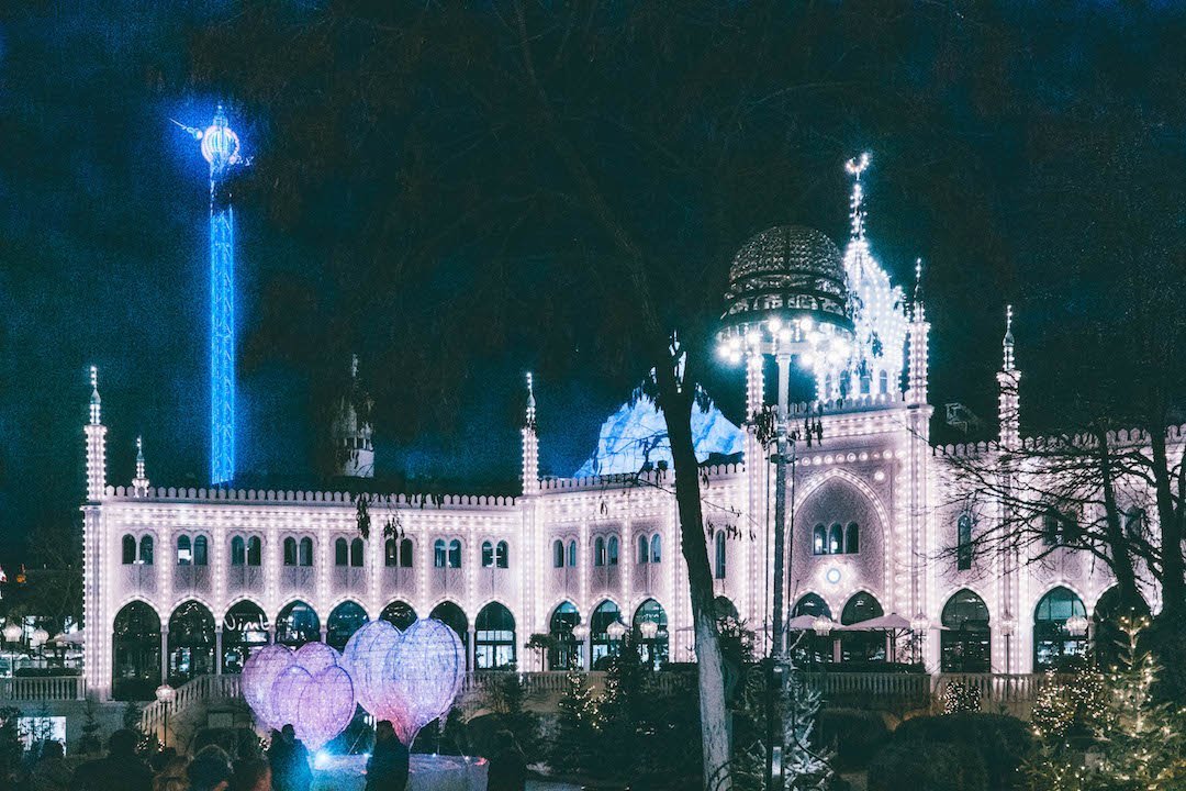 Nimb Hotel in Tivoli Gardens, Copenhagen, lit up at night.