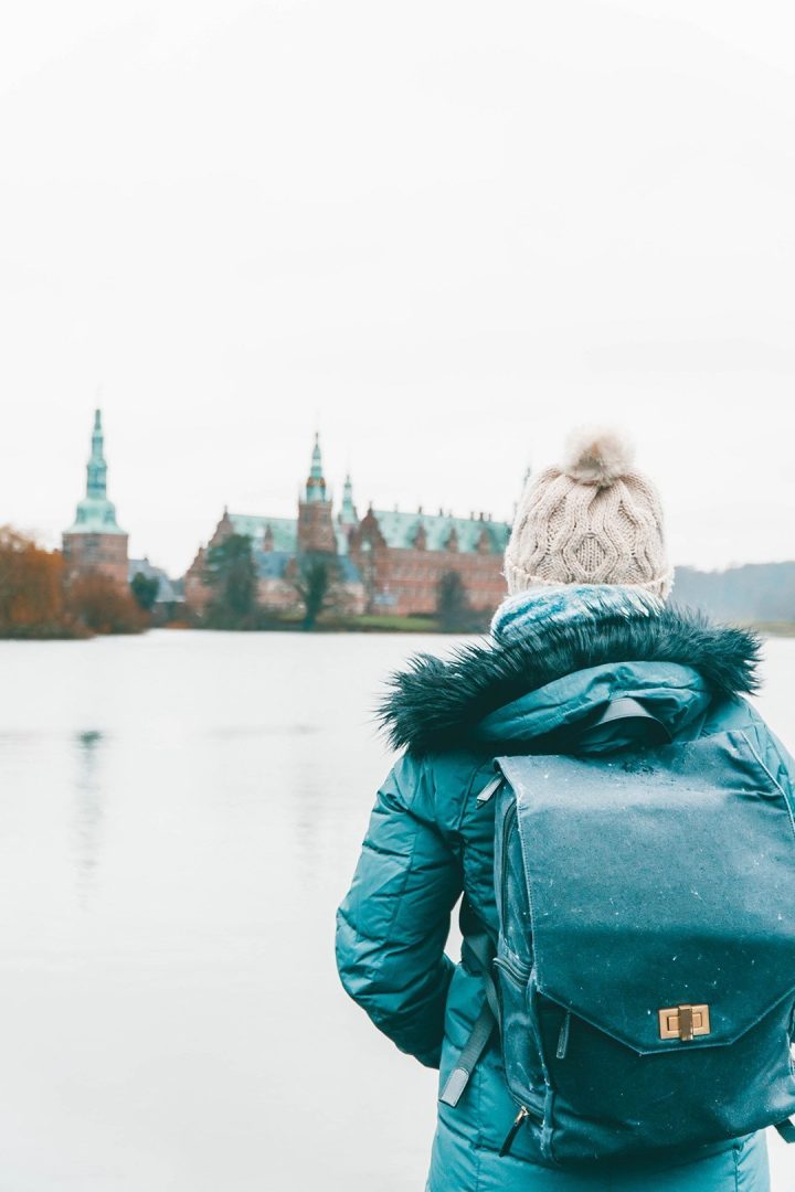 Addie staring across the way at Frederiksbog Castle in Denmark