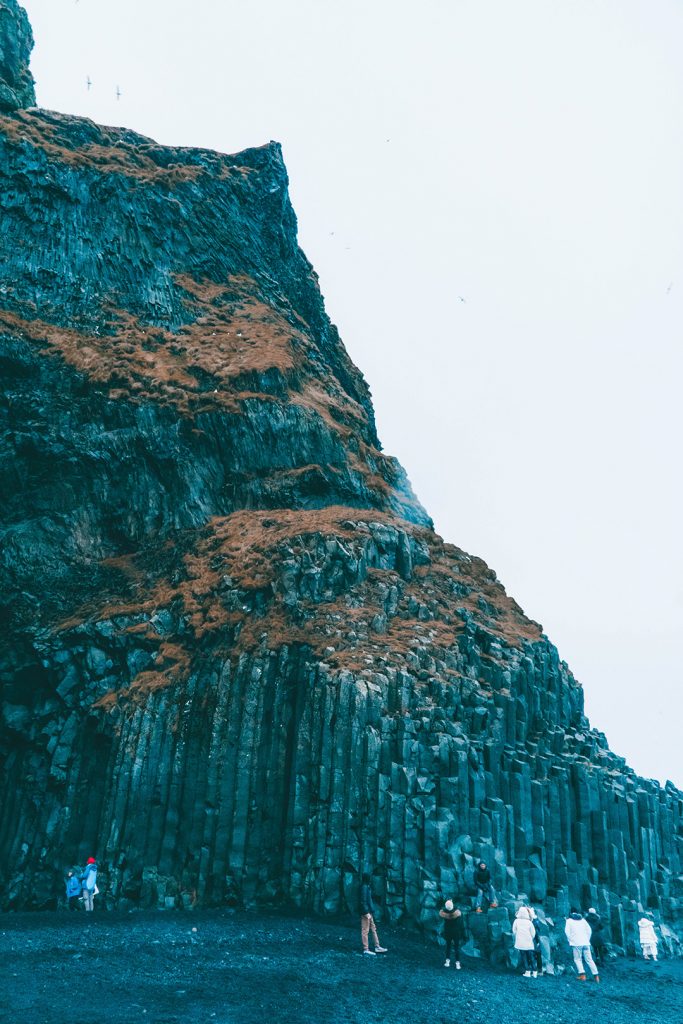 basalt columns on the black sand beach of vik, iceland in december