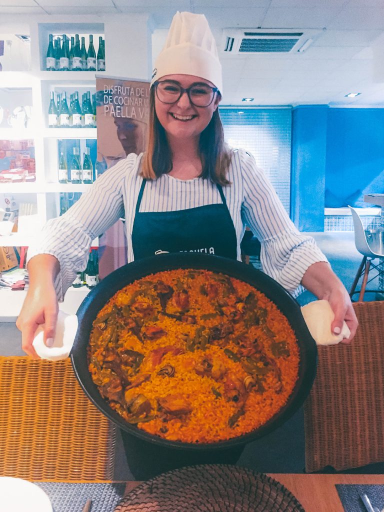Addie holding up the Paella that she cooked during her Paella making class in Valencia, Spain
