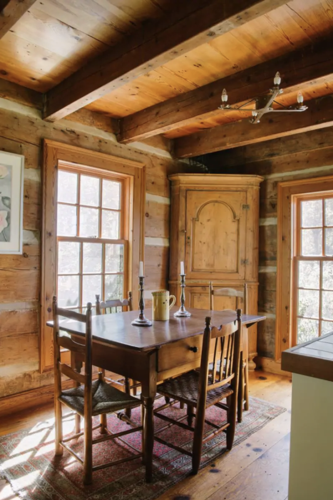 an old fashioned dining room in a log cabin